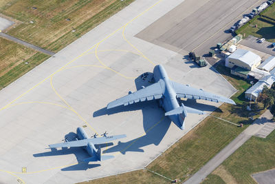 High angle view of airplane flying in airport runway