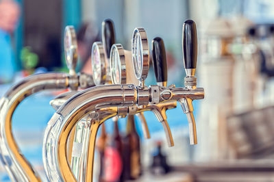 Close-up of beer taps in bar