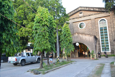 Cars on street amidst buildings in city