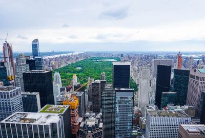 Aerial view of buildings in city against sky