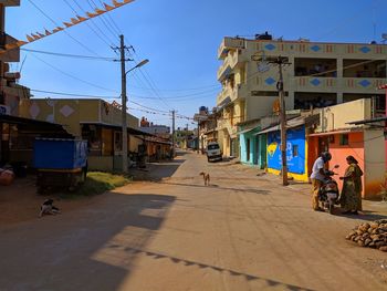 People on street in city against clear sky