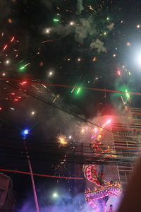 Low angle view of illuminated ferris wheel at night