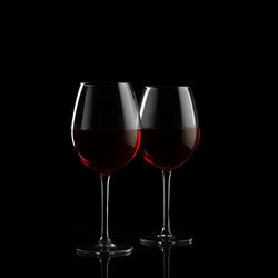 Glass of wine against black background