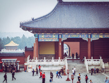 People at temple against sky