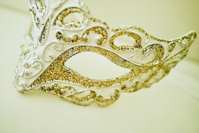 High angle view of gold colored art on white background