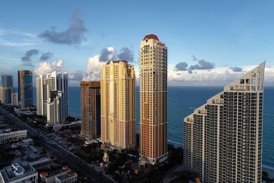 Panoramic view of buildings in city against sky