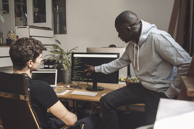 Computer programmers working on coding at workplace