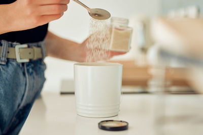 Midsection of woman drinking water