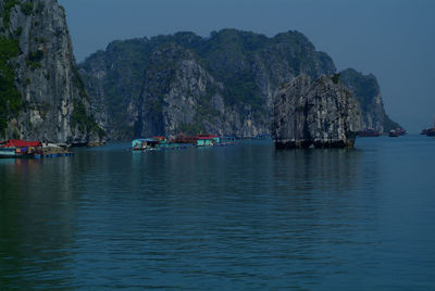 Scenic view of sea and mountains against sky