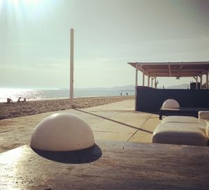 Close-up of table on beach against sky