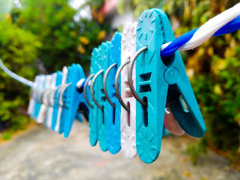 Close-up of clothespins hanging on clothesline