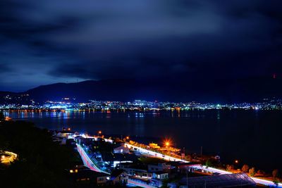 High angle view of illuminated buildings in city at night