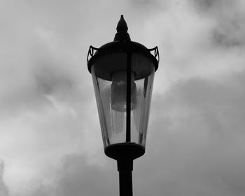 Low angle view of street light against cloudy sky