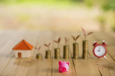 Piggy bank against coins at table