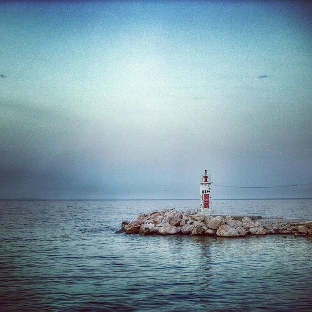 lighthouse, sea, guidance, water, direction, horizon over water, built structure, waterfront, sky, protection, safety, architecture, tranquil scene, tranquility, security, scenics, building exterior, nature, tower, beauty in nature