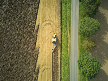 Drone aerial shots of a tractor ploughing a field at stone creek, sunk island, east yorkshire, uk.