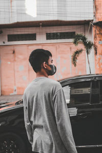 Young man looking at the vehicle before crossing