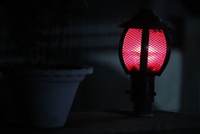 Close-up of illuminated lamp at night