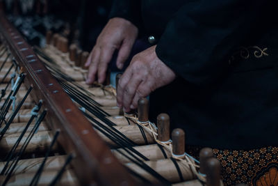 Midsection of man playing piano