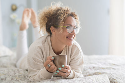 Woman holding while sitting on bed