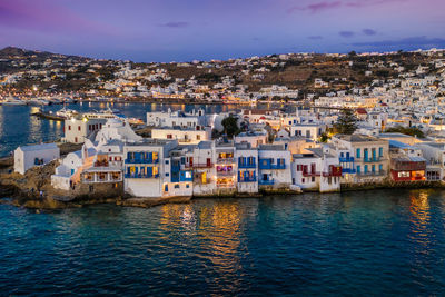 Townscape by sea in town at dusk