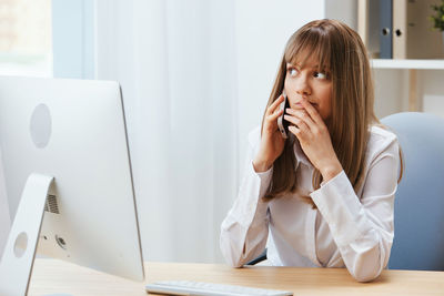 Young woman using laptop at home