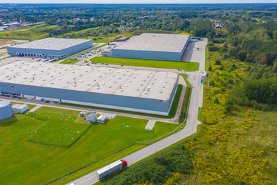 Aerial view of warehouse with trucks driving to the logistic center. industrial background. 