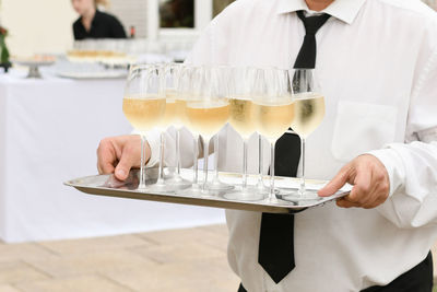 A waiter serving champagne at a wedding