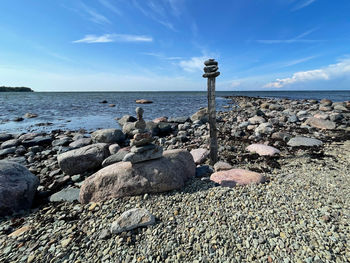 Rocks on beach against sky