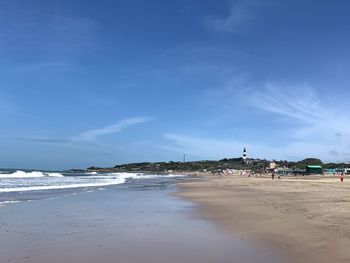 Scenic view of beach against blue sky