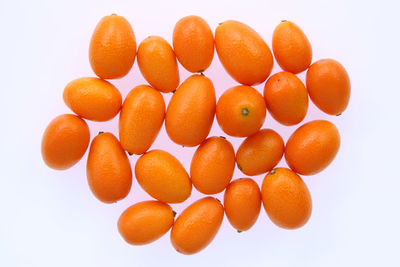 Close-up of orange eggs against white background