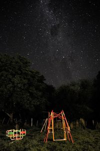 Kids' games on field against sky at night