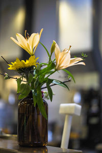 Close-up of yellow flower vase on table