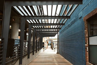 Rear view of man walking in corridor of building