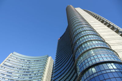 Low angle view of office building against blue sky