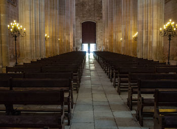 Empty benches in illuminated building