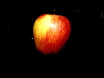 Close-up of apple against black background