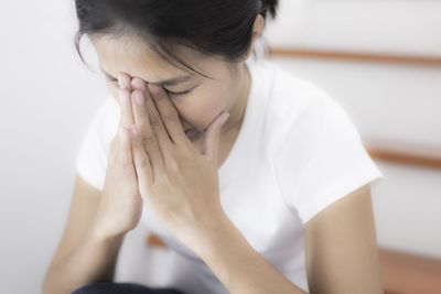 Close-up of woman sitting on floor
