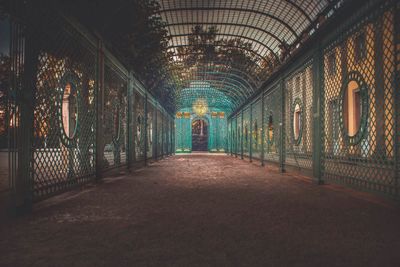 Empty corridor in illuminated building