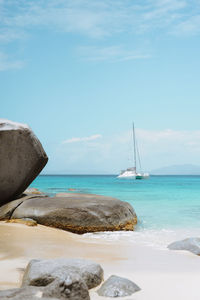 Scenic view from shore, of a sailboat