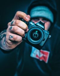 Midsection of man holding camera