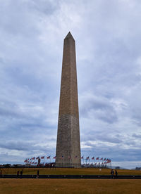 Low angle view of washington monument against cloudy sky