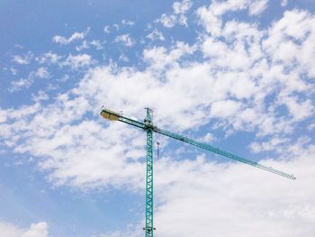 Low angle view of crane against sky