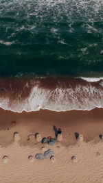 High angle view of people on sand at beach