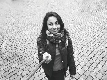 Portrait of smiling young woman standing outdoors