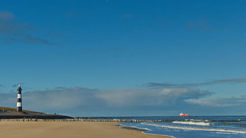 Scenic view of beach against blue sky