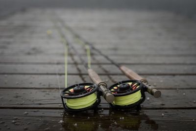 Close-up of fishing rods on wood