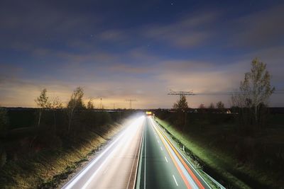 Road amidst trees against sky