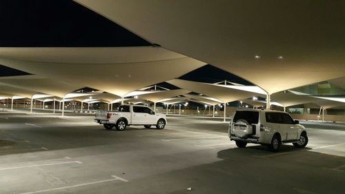 Car on illuminated street at night