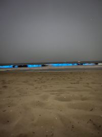 Scenic view of beach against sky at night